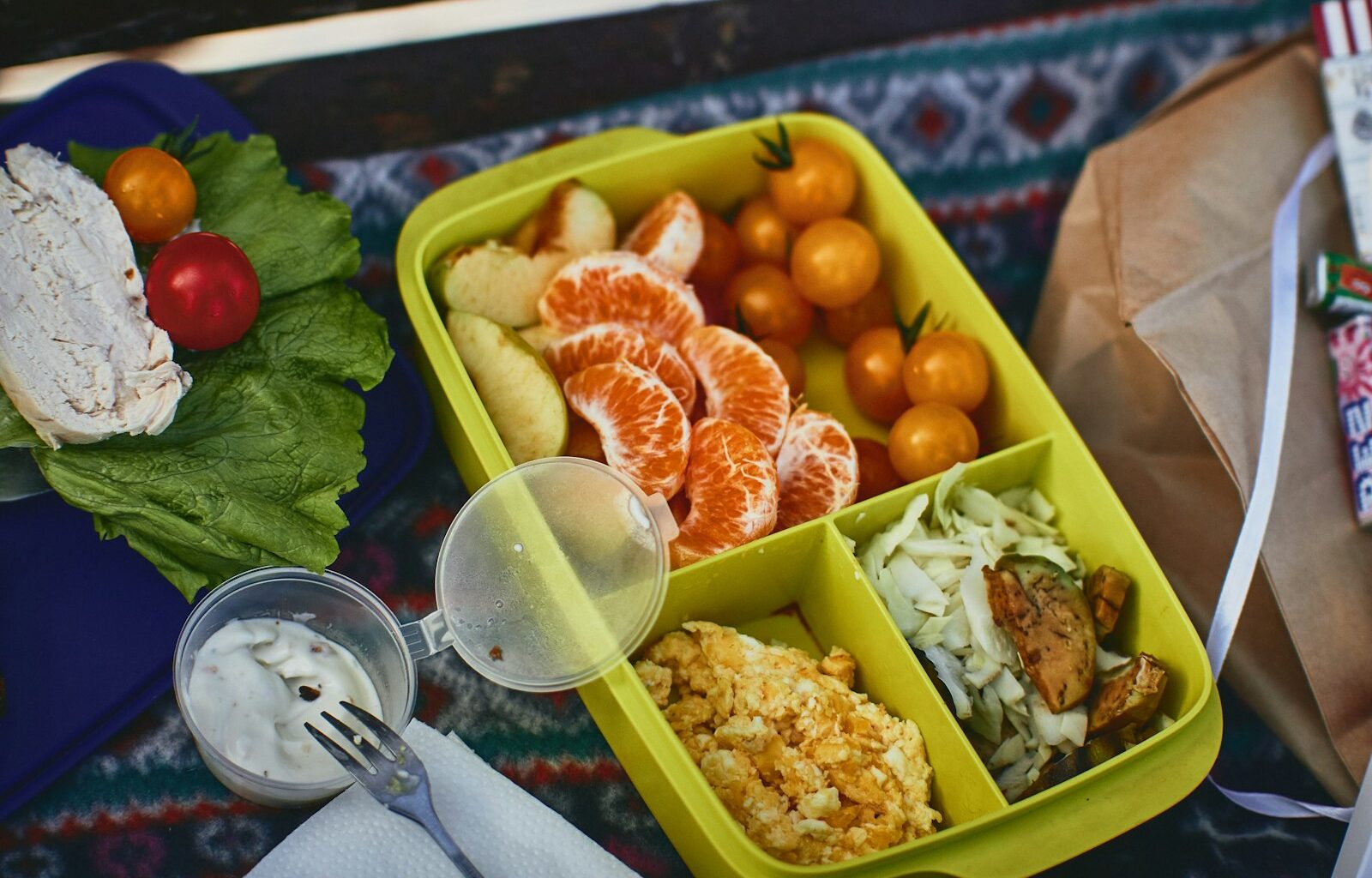 Lunchbox met een volkoren wrap, groente, fruit en een waterfles